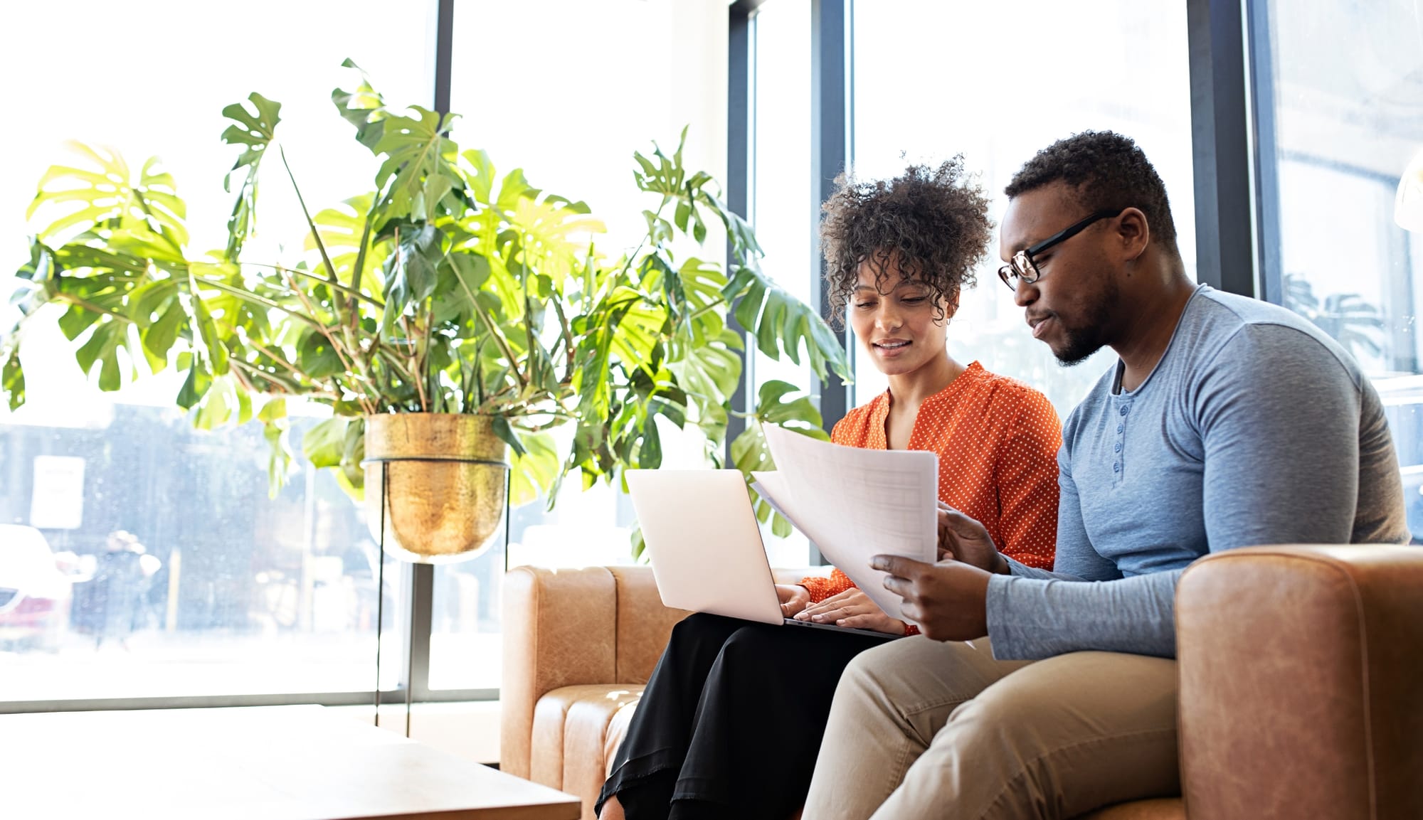 A person reviewing documents with a debt counselor for guidance.